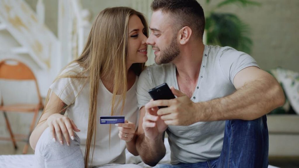 Authorized User Strategy for Earning Points Faster 4 Couple reviewing a purchase together with a credit card