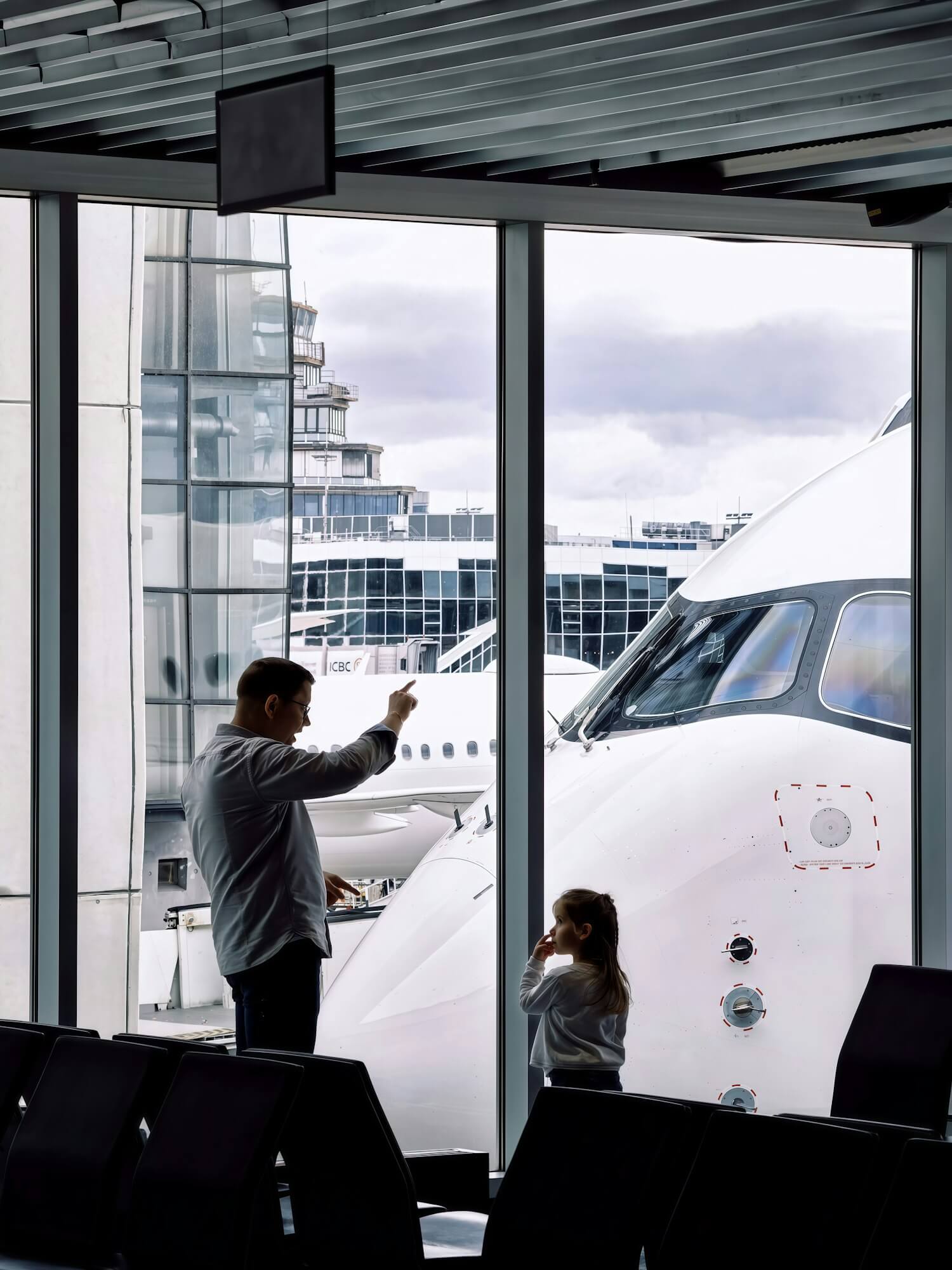 British Airways Household Account: How to Pool Avios With Family 1 Father and daughter at an airport gate, a family traveling together on pooled Avios