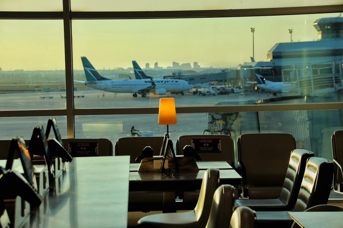 Priority Pass Restaurants and Digital Membership: What's Actually Still Included 4 Airport lounge dining table with a view of the tarmac, similar to a Priority Pass restaurant setting