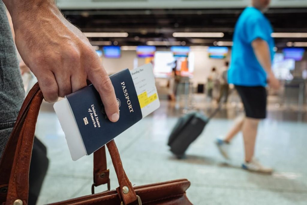 Traveler holding a passport and boarding pass at the airport