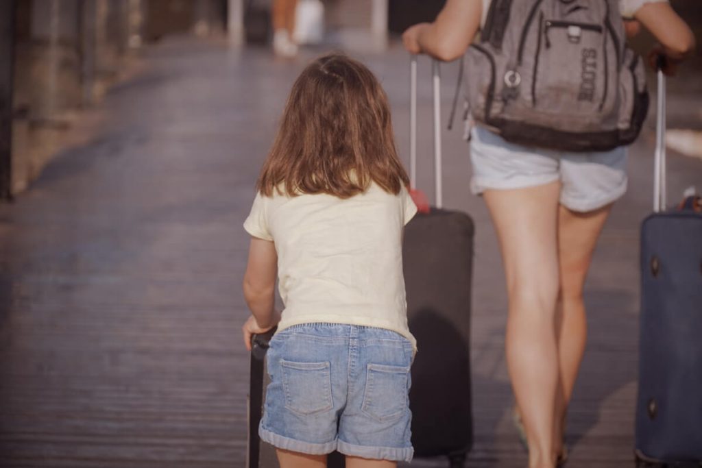Can Southwest Points Be Transferred? To Another Person, Chase, or Another Airline 3 Mother and daughter traveling together with rolling luggage