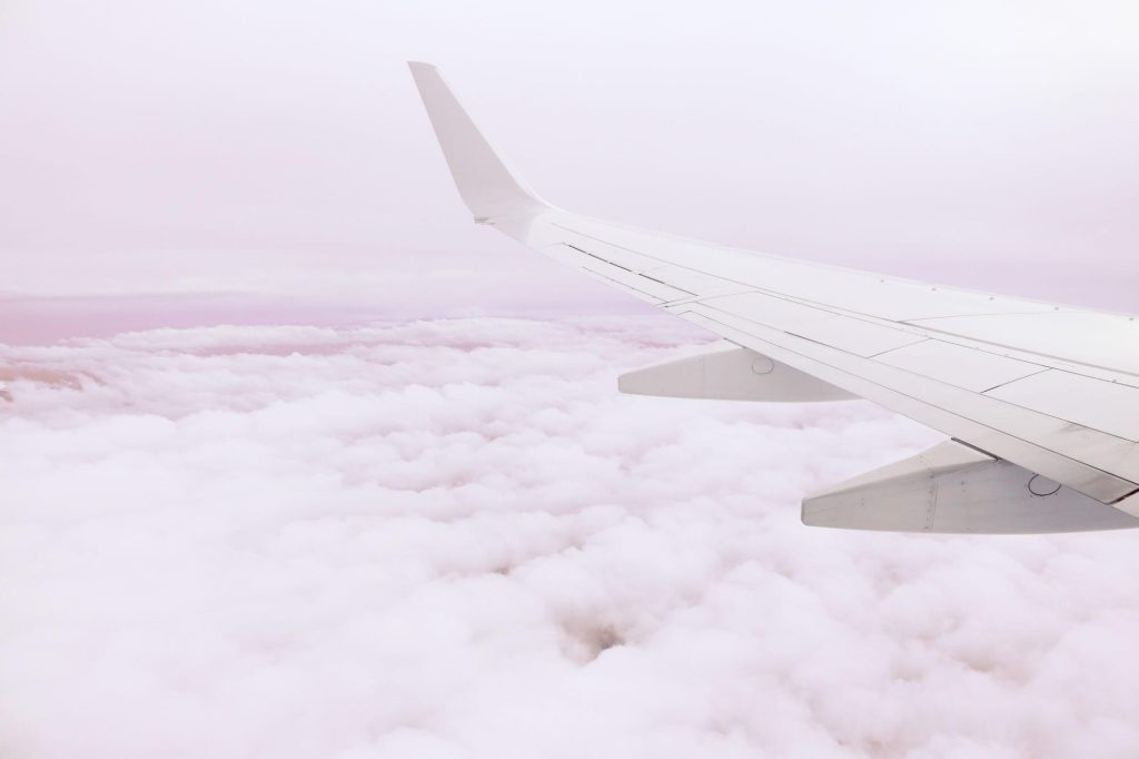 Earn Double Etihad Guest Miles on JetBlue Flights (Through November 30, 2026) 12 Airplane wing above clouds at altitude