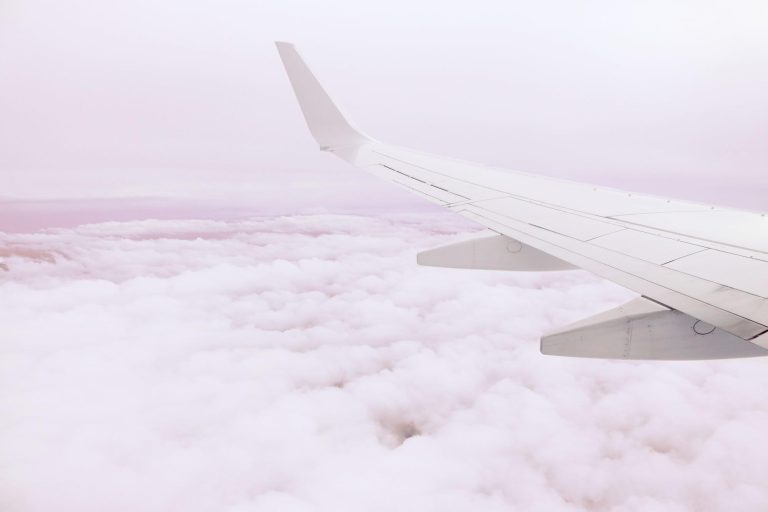 airplane wing above clouds