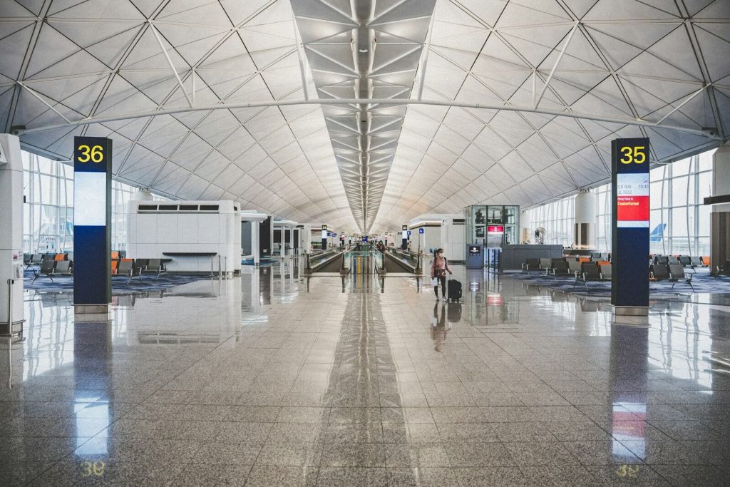 Wide airport terminal gate area, the kind of place a ticket number gets checked