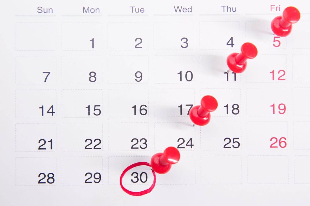 AwardWallet Paywalls Expiration Alerts on Its Free Tier 5 Calendar with red pins marking upcoming dates