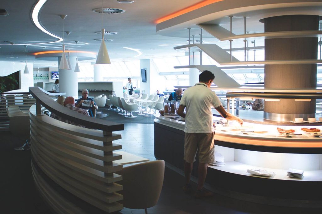 Premium airport lounge with buffet and seating