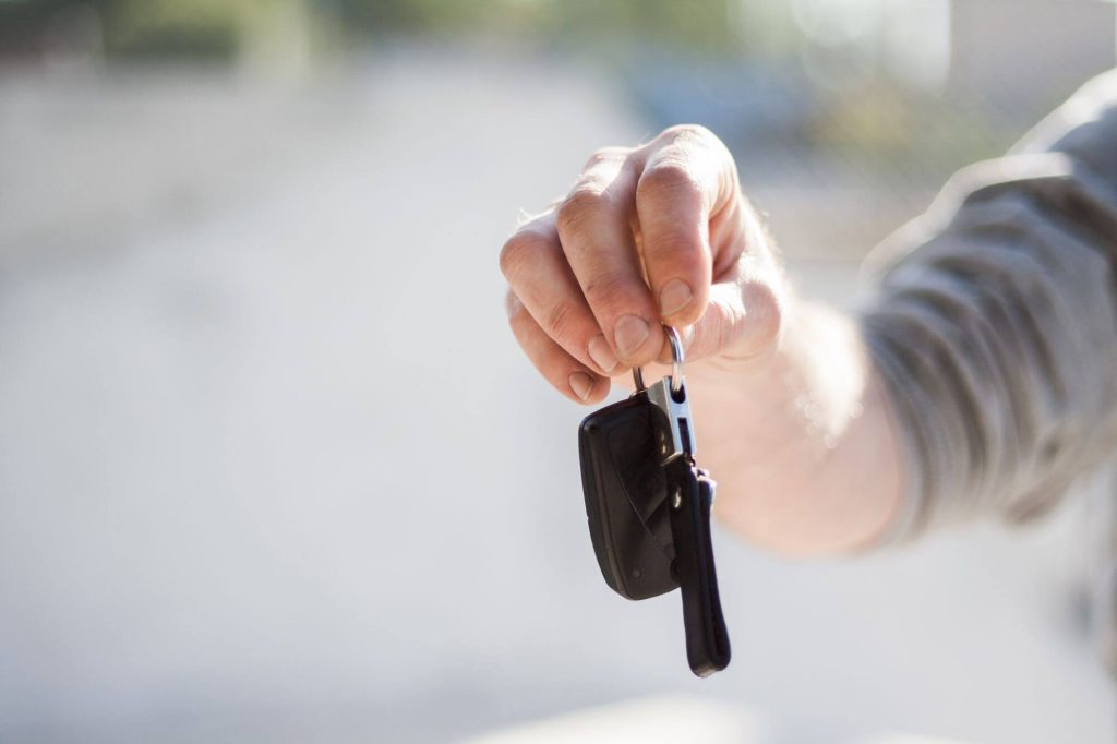 Person handing over car keys