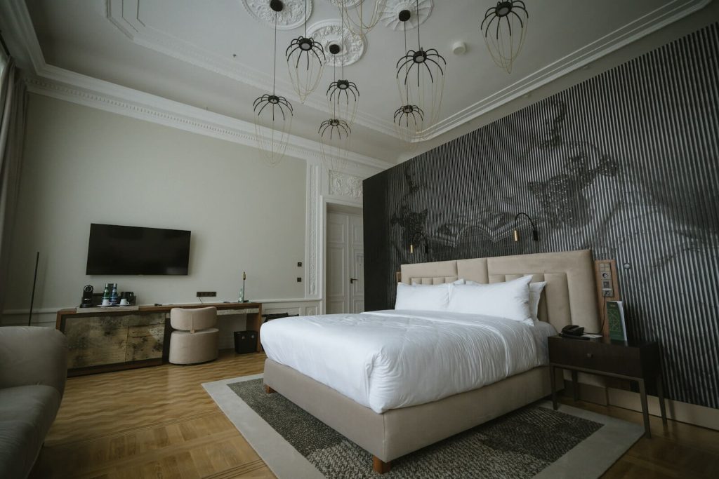 Elegant hotel suite bedroom with statement lighting