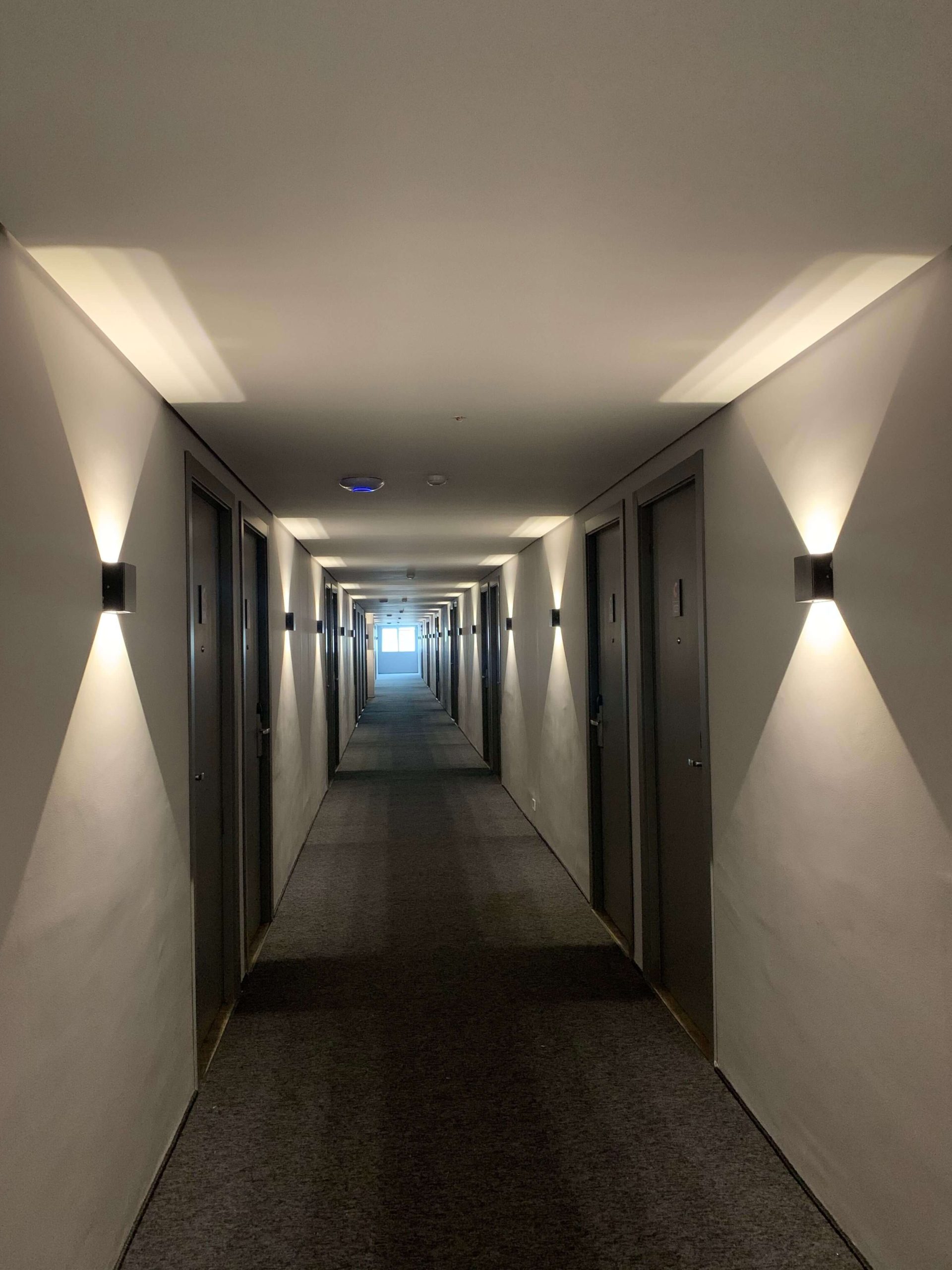 Can You Earn Marriott Elite Night Credits at Two Hotels on the Same Night? 6 Modern hotel hallway with doors