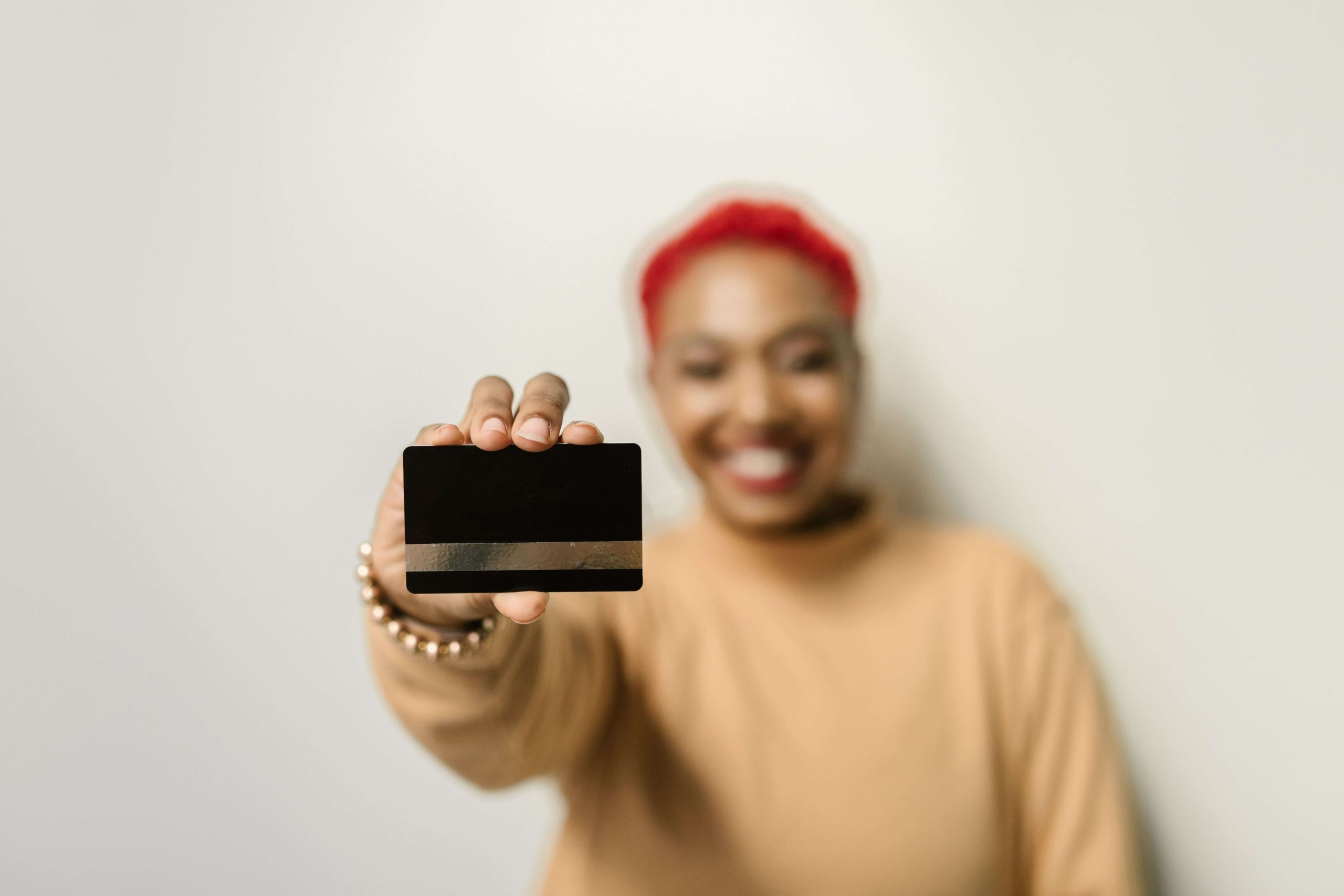 Wells Fargo Is Ending Rewards Gifting and Auto-Redemptions on September 25 2 Person holding a blank credit card