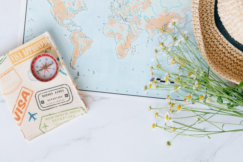 British Airways Lifetime Gold Status: How Lifetime Tier Points Work 2 World map with compass and passport, symbolizing a lifetime of travel