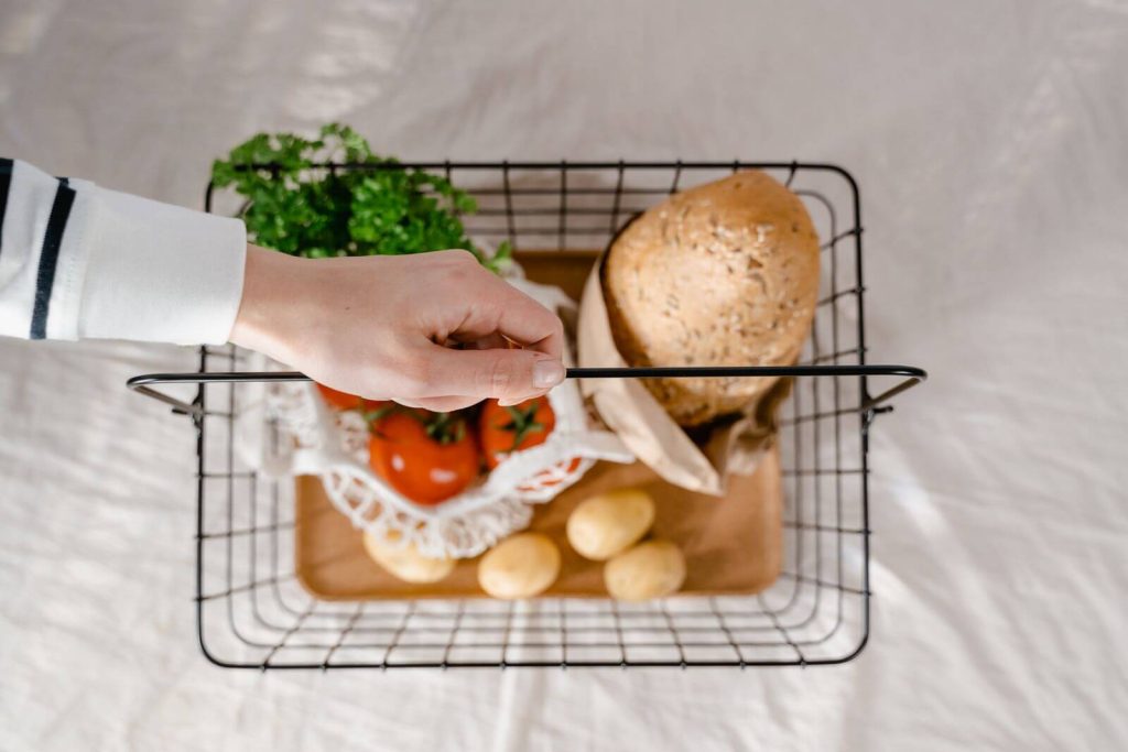 Citi / AAdvantage MileUp Card Review: Is a No-Fee AA Card Worth It? 5 Hand placing fresh produce into a grocery basket