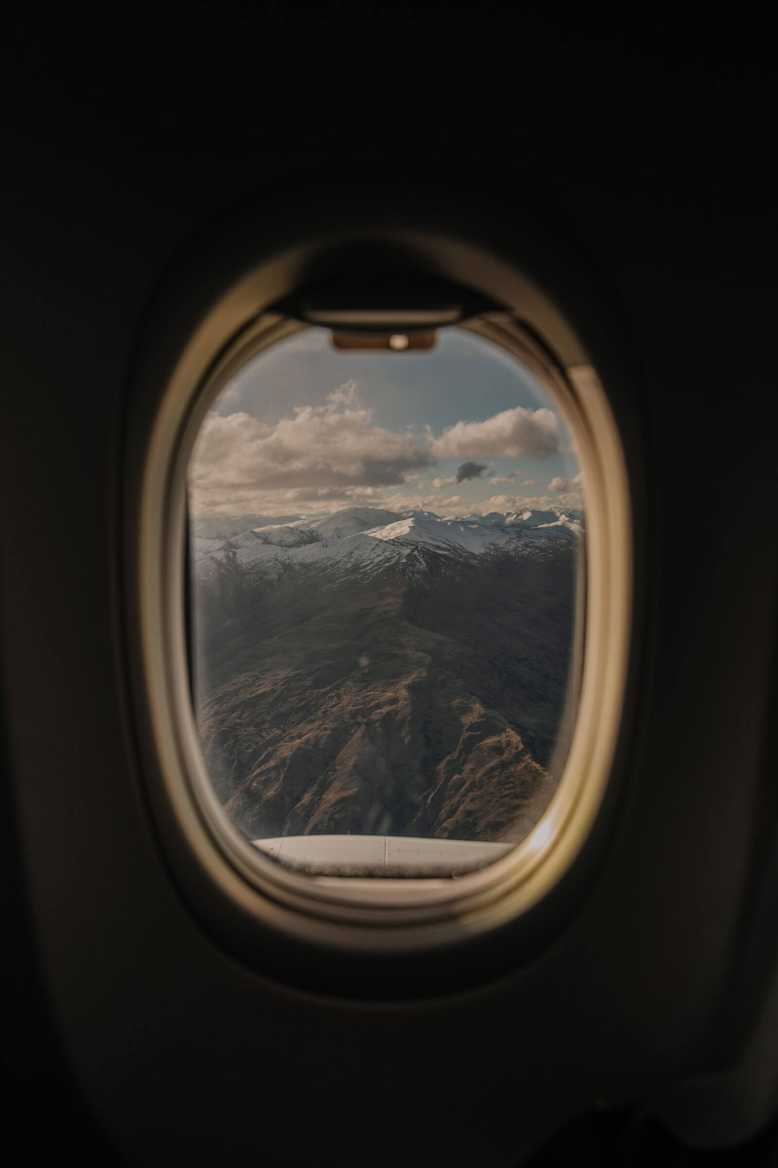 Citi / AAdvantage Platinum Select Card Review: Is the $99 Fee Worth It? 6 Snow-capped mountains seen through an airplane window