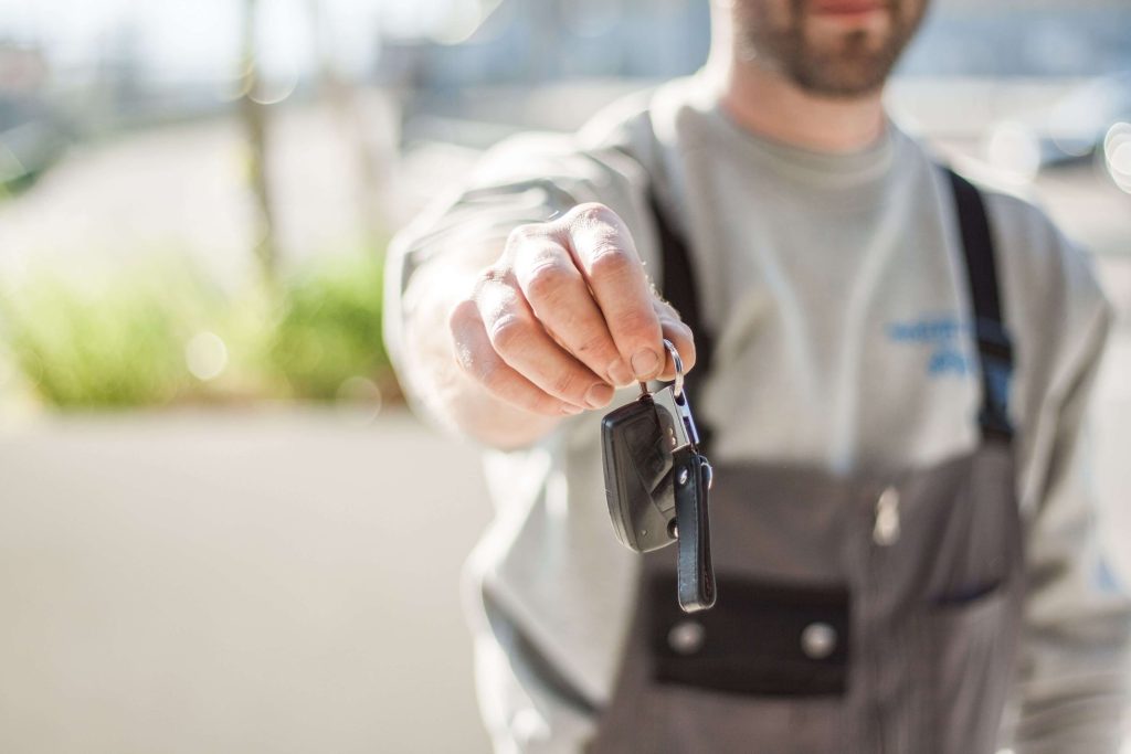 IHG Quietly Changes Its Hertz Partnership Points Structure 13 Person handing over a car rental key, representing the IHG-Hertz points partnership