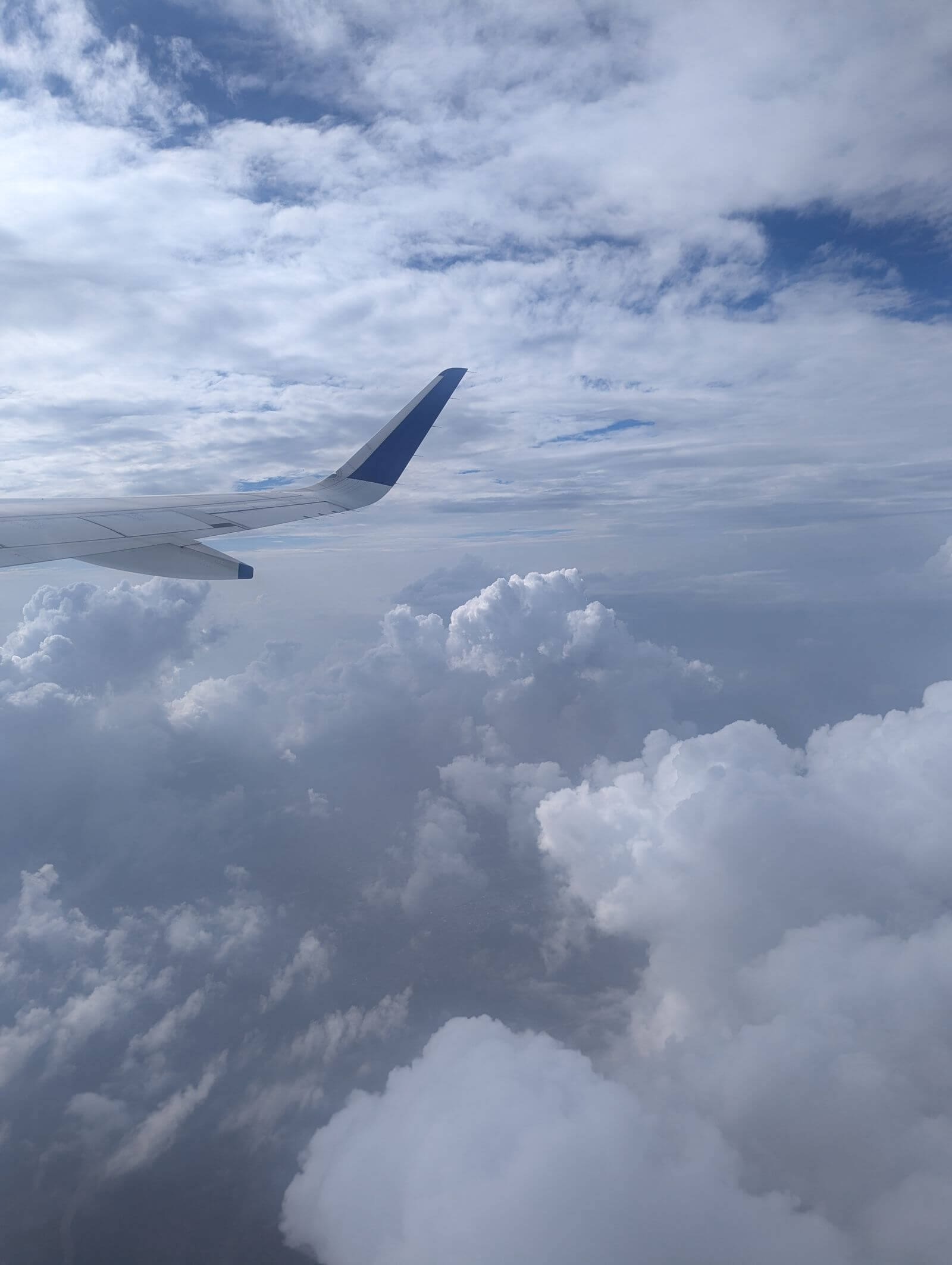 United Business Card Review: Is the $150 Fee Worth It? 8 Airplane wing above clouds during flight
