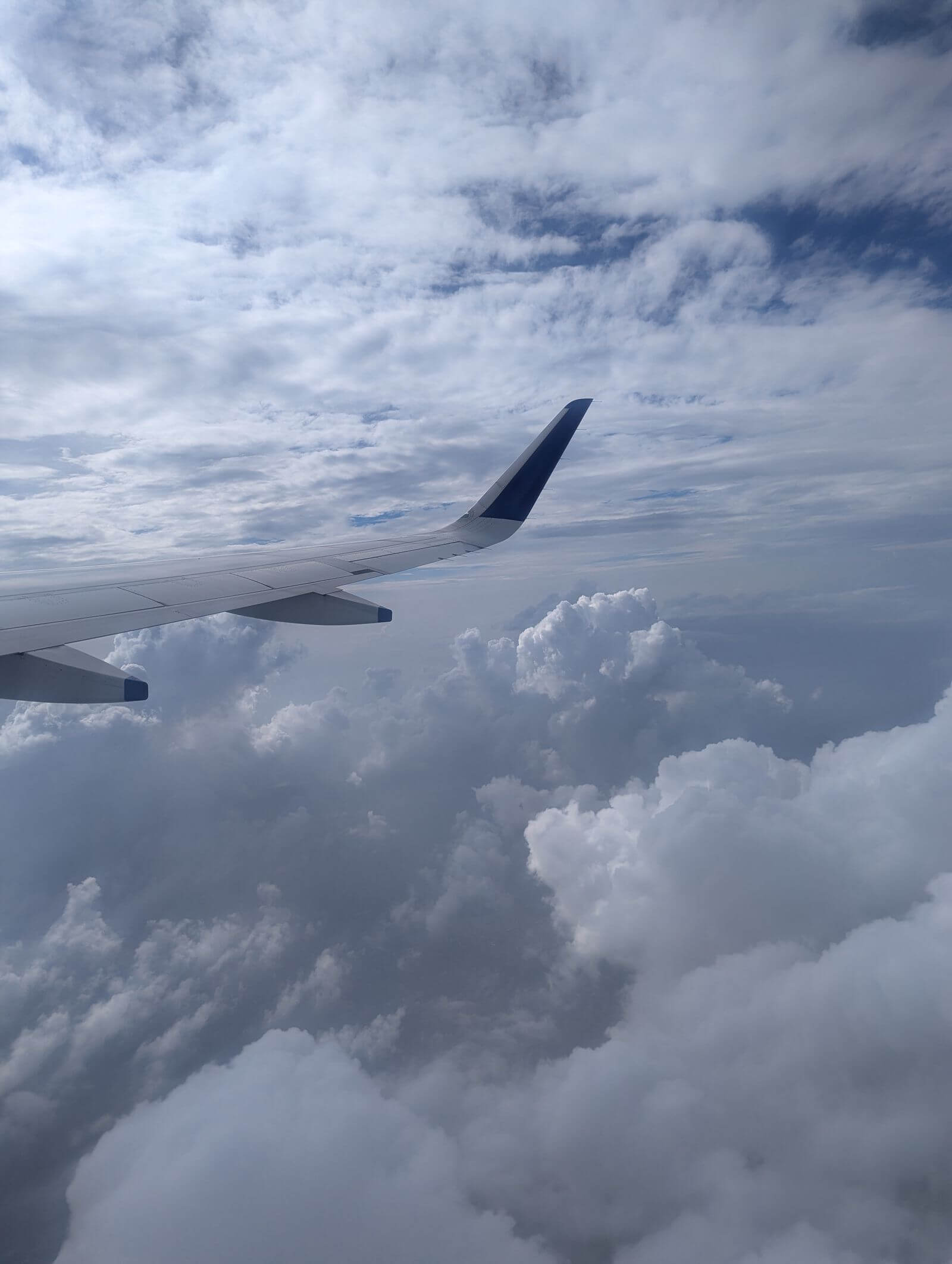 United Quest Card Review: Is the $350 Fee Worth It? 9 Airplane wing above thick clouds during flight